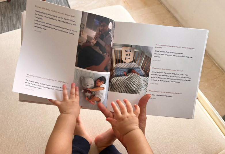 Baby hands and father hands holding the memory book